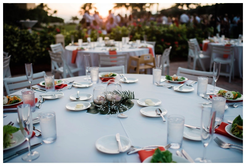 Simple, tropical centerpieces adorn outdoor wedding reception tables in Marco Island, Florida.