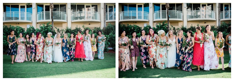 Bride stands among bridesmaids all dressed in tropical, bright colored summer dresses.