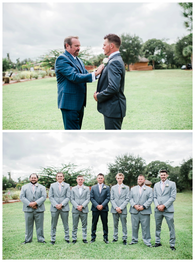 Groomsmen suit up for wedding day in light grey suits with pale pink ties.