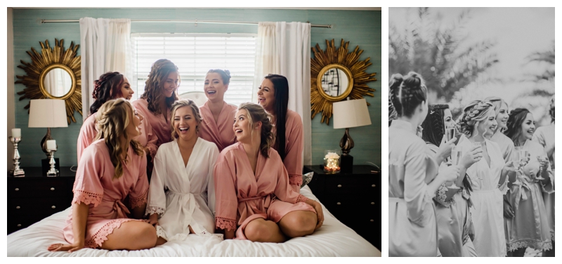 Bridesmaids laugh as they get ready for the wedding in pale pink and white silk robes.