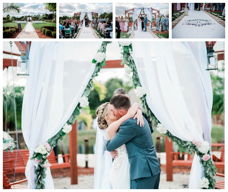 Bride and groom kiss under floral arbor.