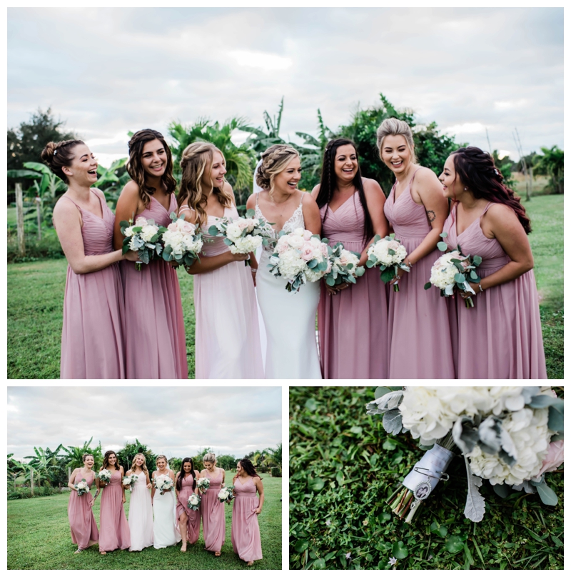 Bride and bridesmaids stand in pale pink bridesmaids gowns smiling in celebration.