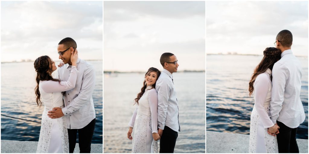 couple poses in front of water for engagement session