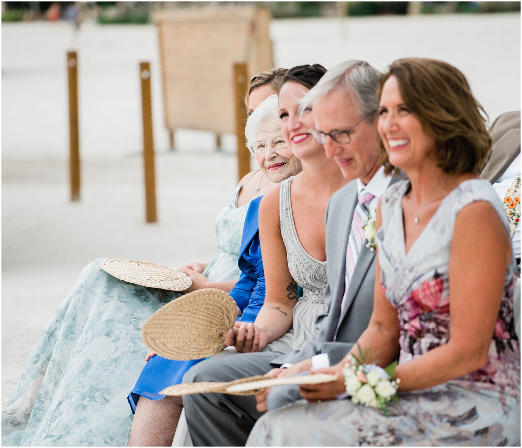 Family of the groom smile during ceremony on wedding day at JW Marriott Marco Island in Florida.