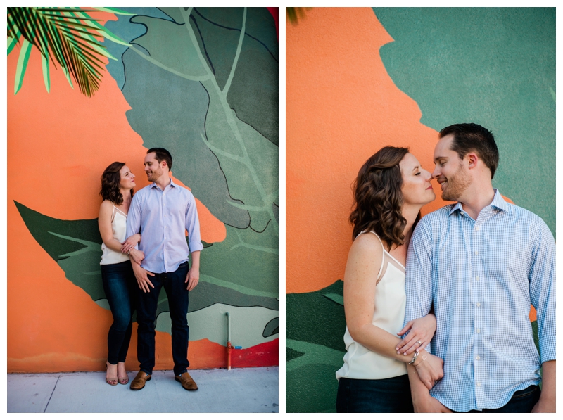 Bright orange and palm colored mural wall stands as a perfect engagement session backdrop.