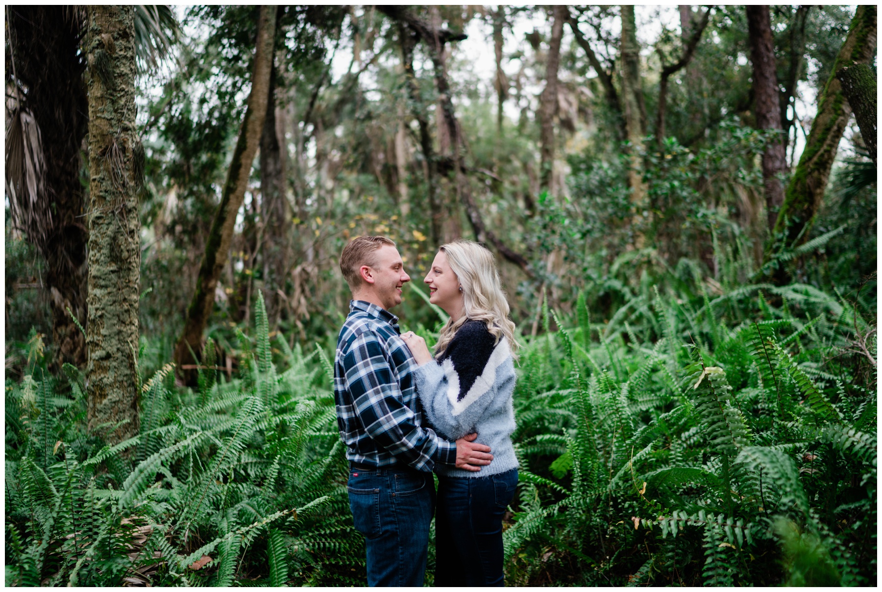 Couple embraces in swap greenery during Florida photoshoot.