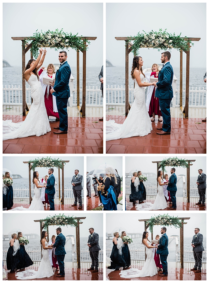 Bride and groom stand oceanside during rainy wedding ceremony