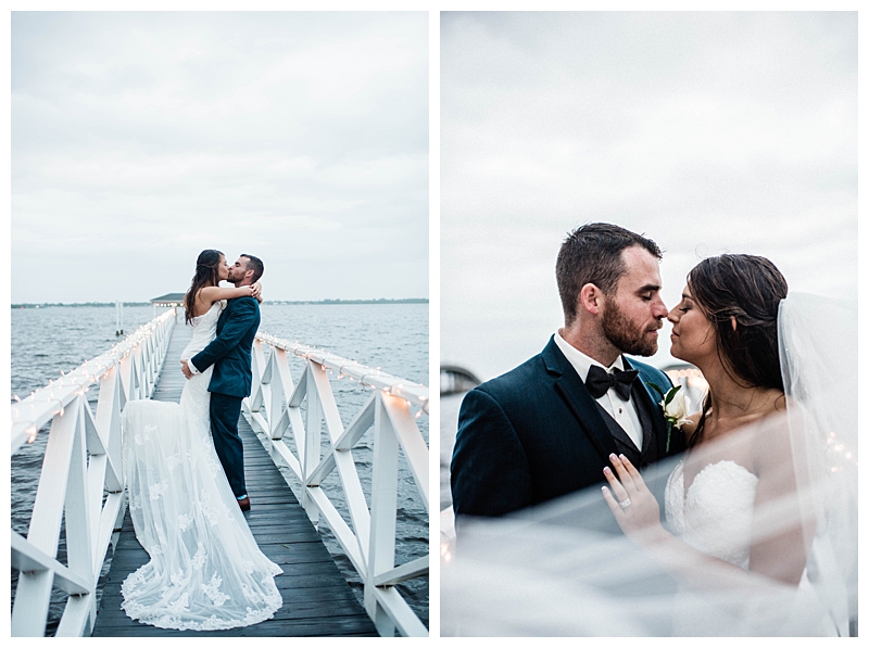 Bride and groom kiss in the rain on boardwalk over Florida water scenery