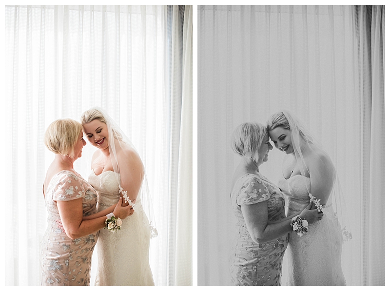 Mother of the bride embraces bride on morning of Florida wedding day