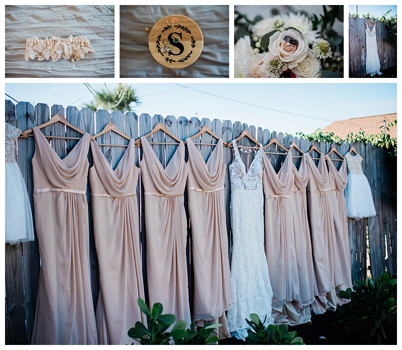 Soft beige bridesmaids gowns hang with bride's accessories.