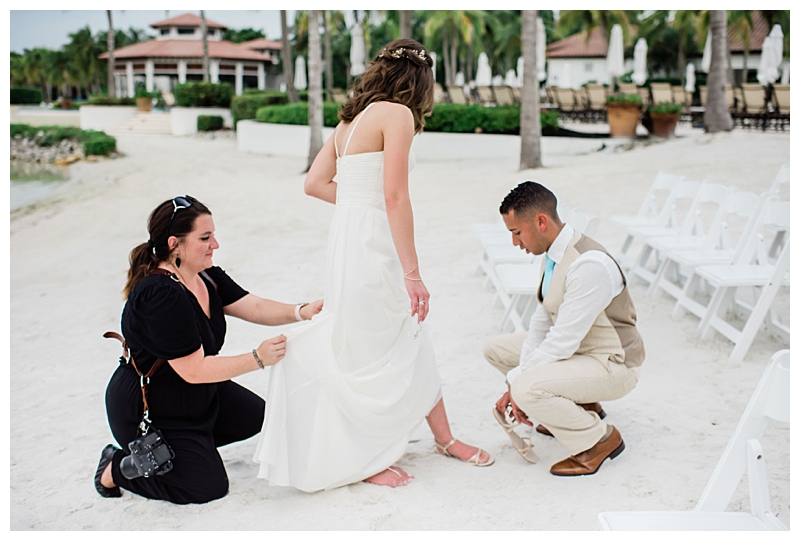 Southwest Florida photographer assists beach bride with wedding dress