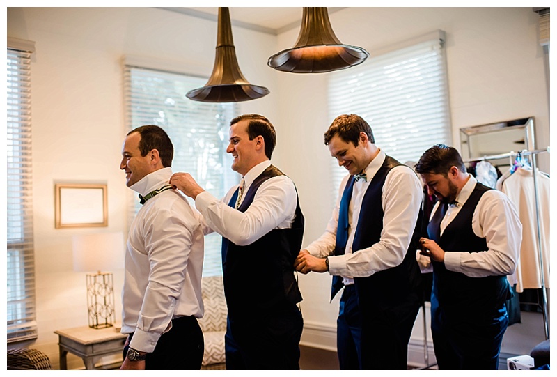 Groomsmen help each other get ready on Southwest Florida wedding day