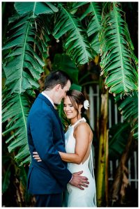 Bride and groom portrait among tropical Florida greenery
