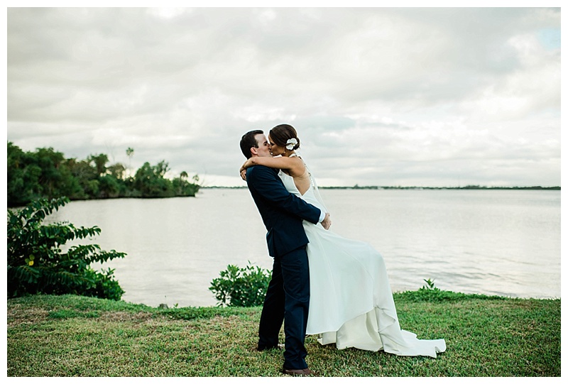 Bride and groom kiss waterfront on Southwest Florida wedding day