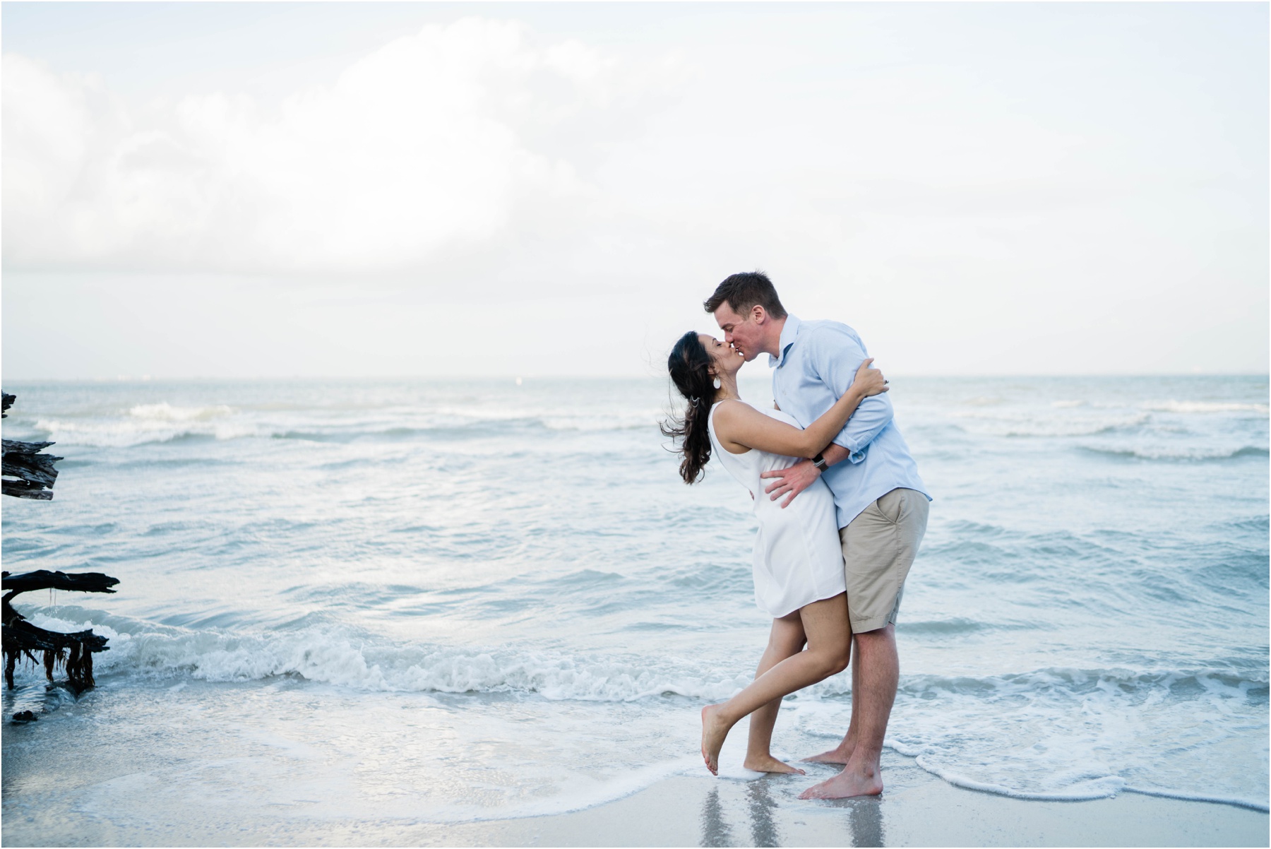 Engaged couple kisses on Sanibel Island beach during engagement session