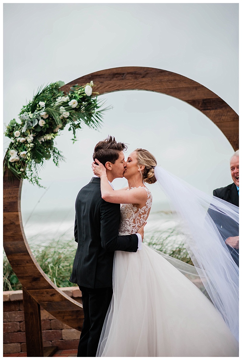 Bride and groom share first kiss at Harbor House Oceanfront Venue