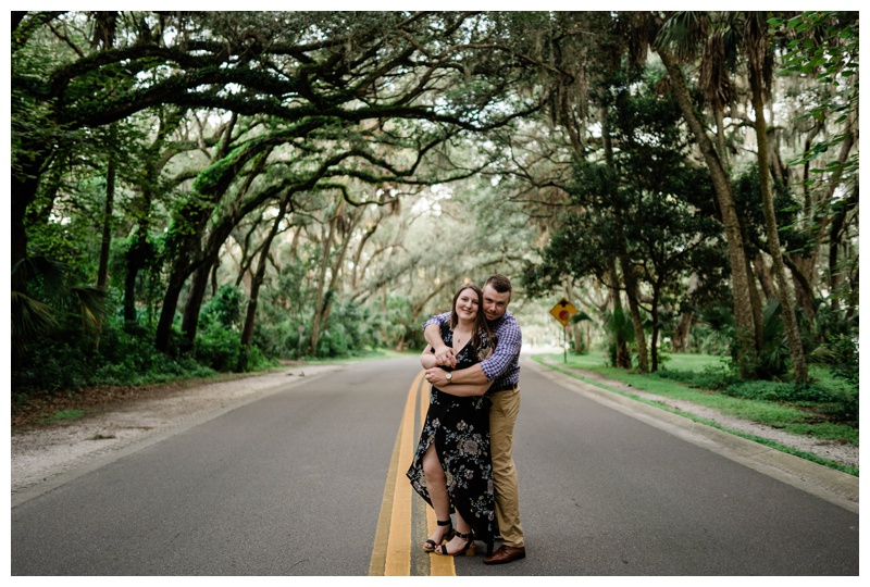 engaged couple embraces surrounded by willow trees during Southwest Florida photoshoot