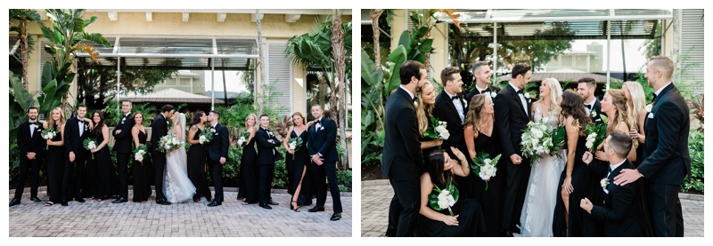 Bridal party embraces during Florida wedding with black bridesmaids gowns and black and white tuxedos