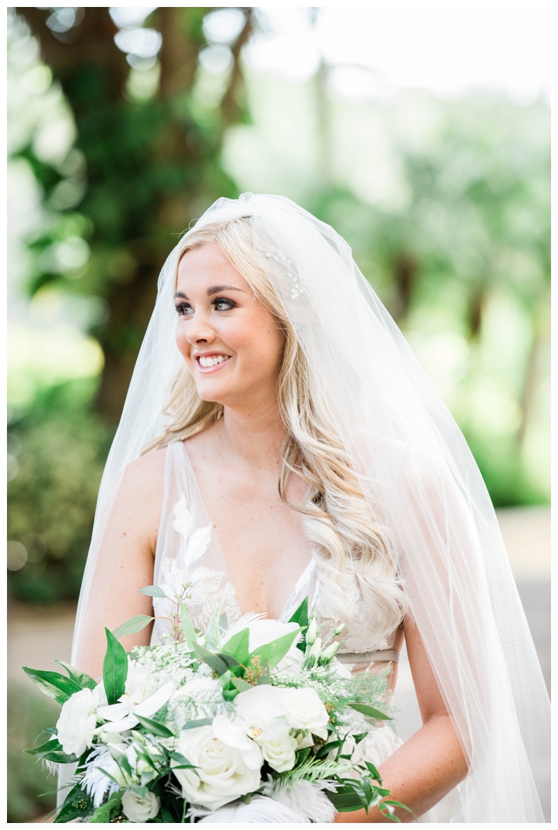 Florida bride holds white and green bridal bouquet