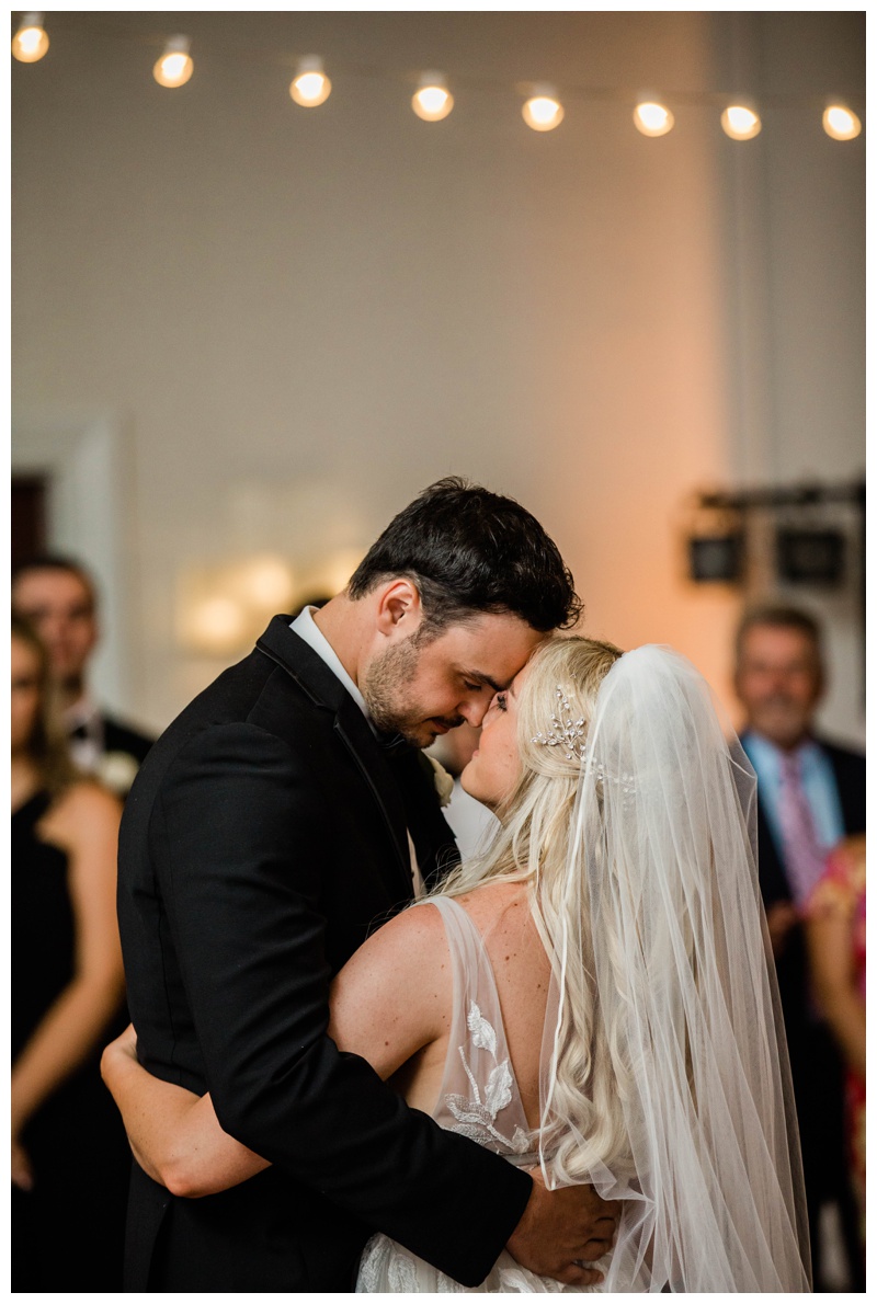 Florida bride and groom embrace during their first dance as husband and wife