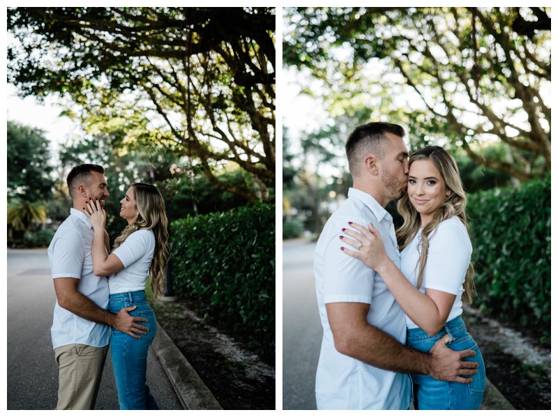 couple hugs under tree during Naples engagement photoshoot