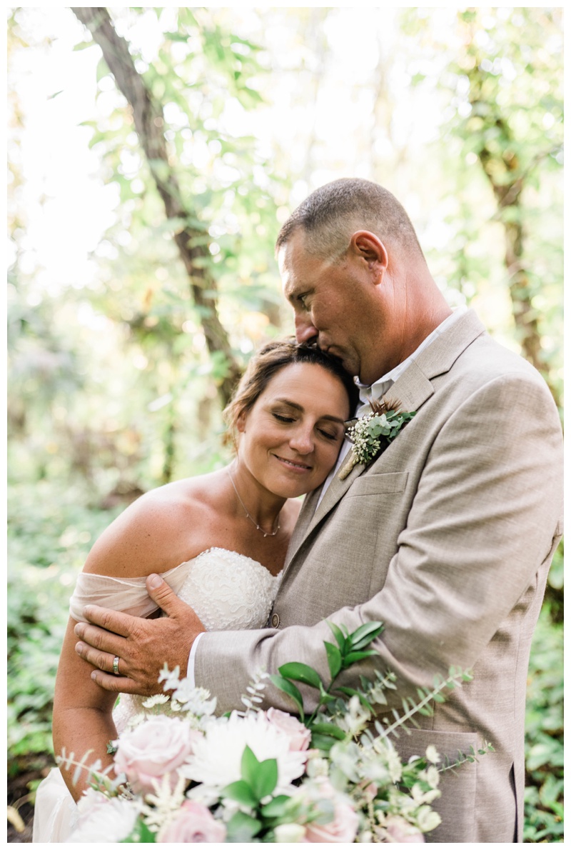 Southwest Florida wedding photographer captures bride and groom embracing during newlywed portraits