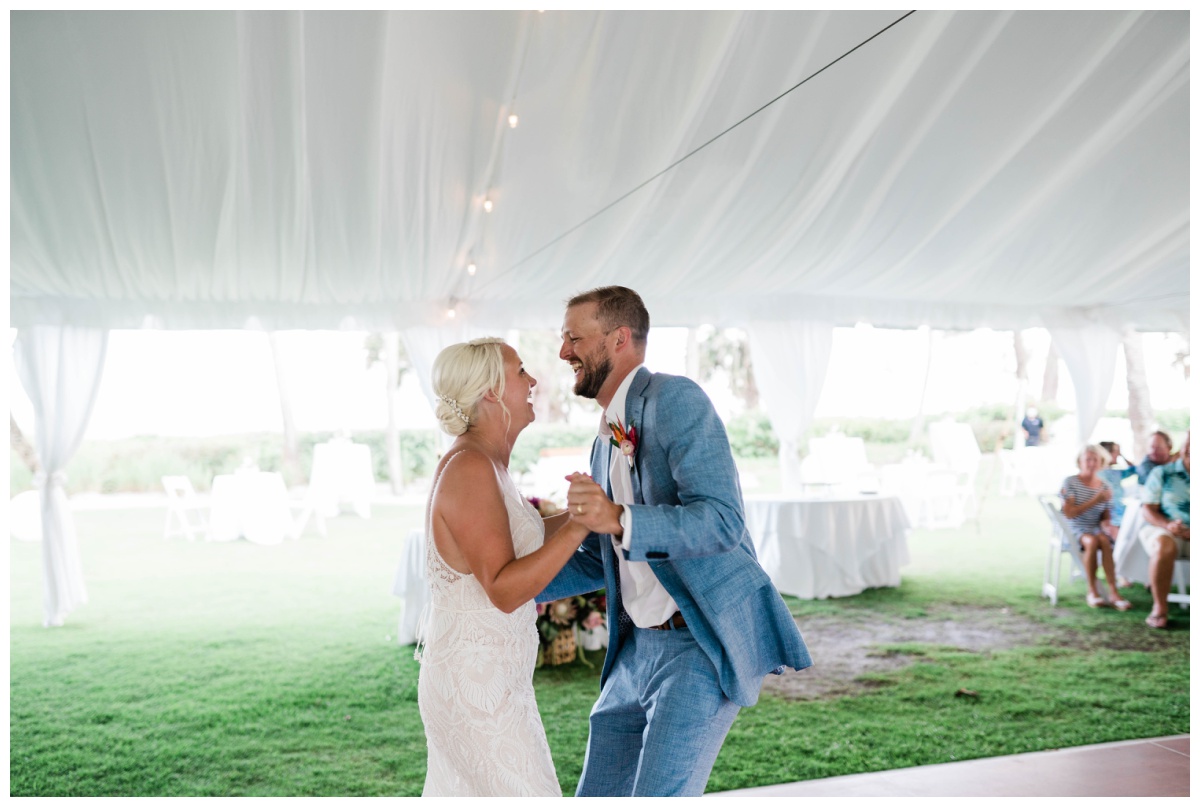 bride and groom laugh during first dance as husband and wife on Florida wedding day