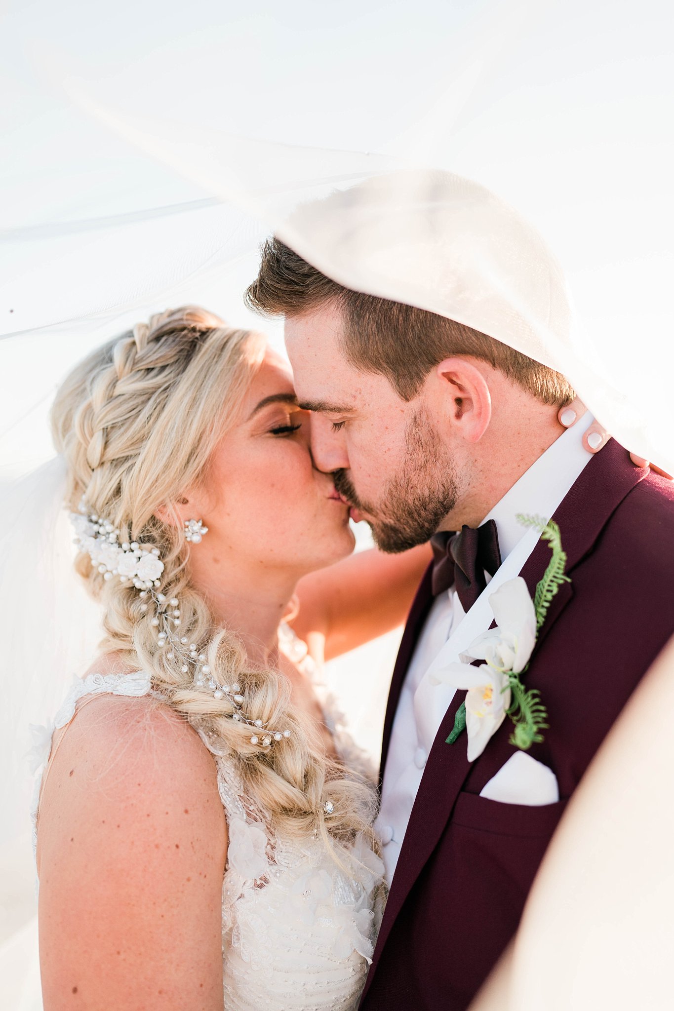 beach bride and groom kiss under bridal veil on Casa Ybel wedding day
