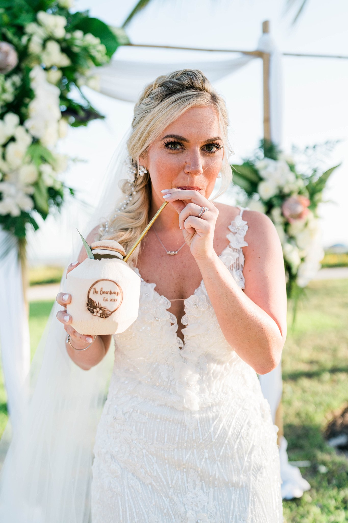 tropical bridal style bride drinks out of coconut on tropical wedding day in FLorida