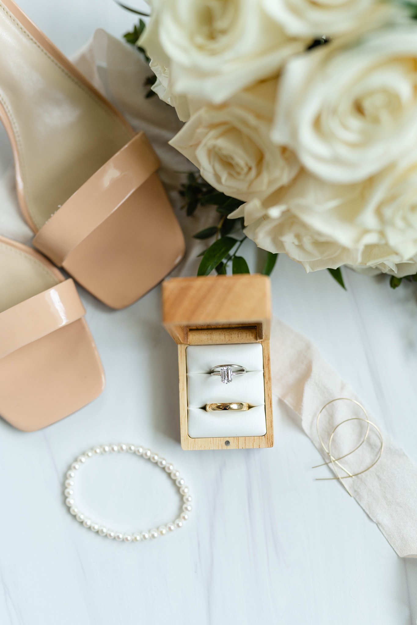 Southwest Florida photograph captures beach bridal details of emerald cut engagement ring and white rose bouquet